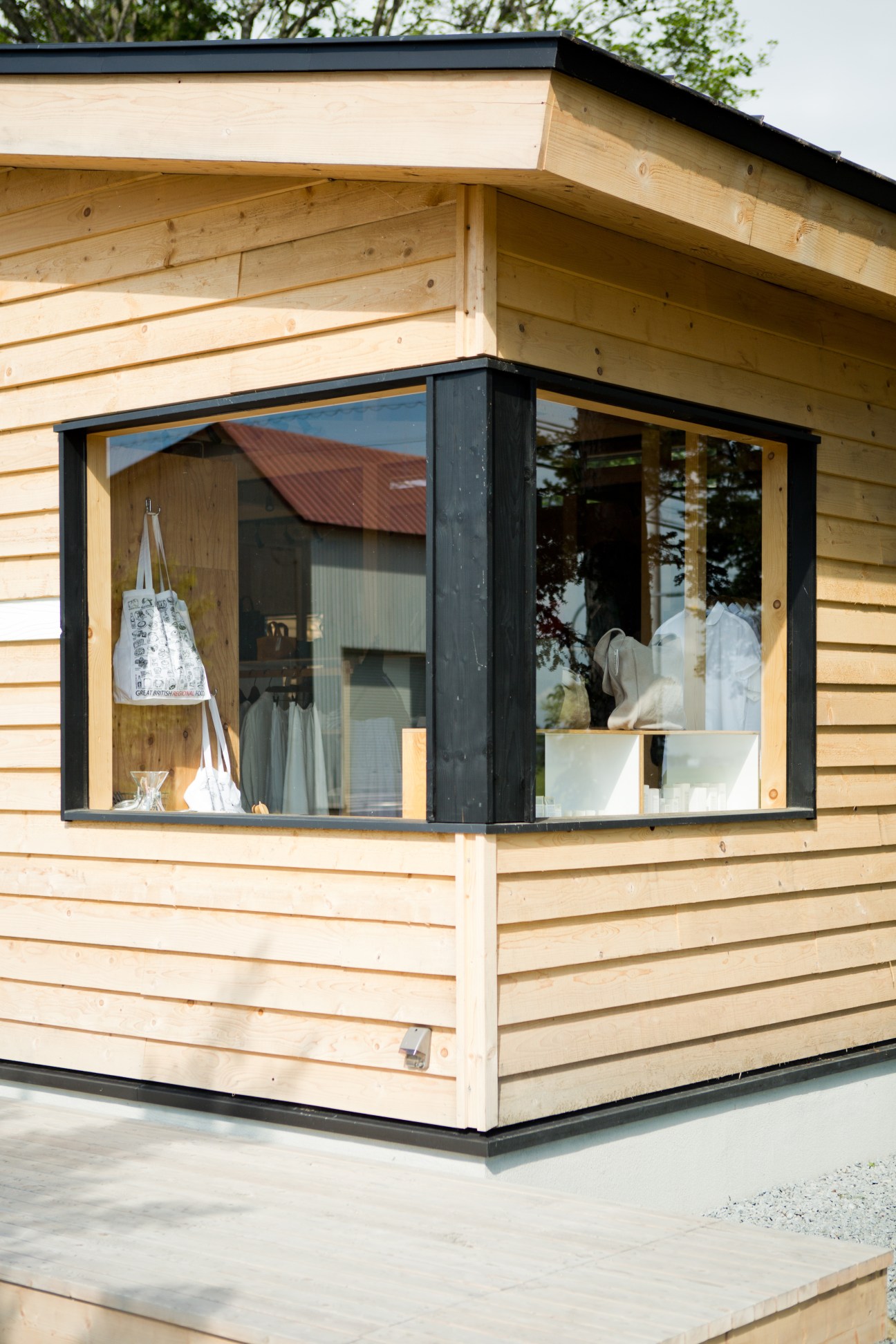 Salt boutique's modern clapboard exterior with large windows displaying clothing and accessories.