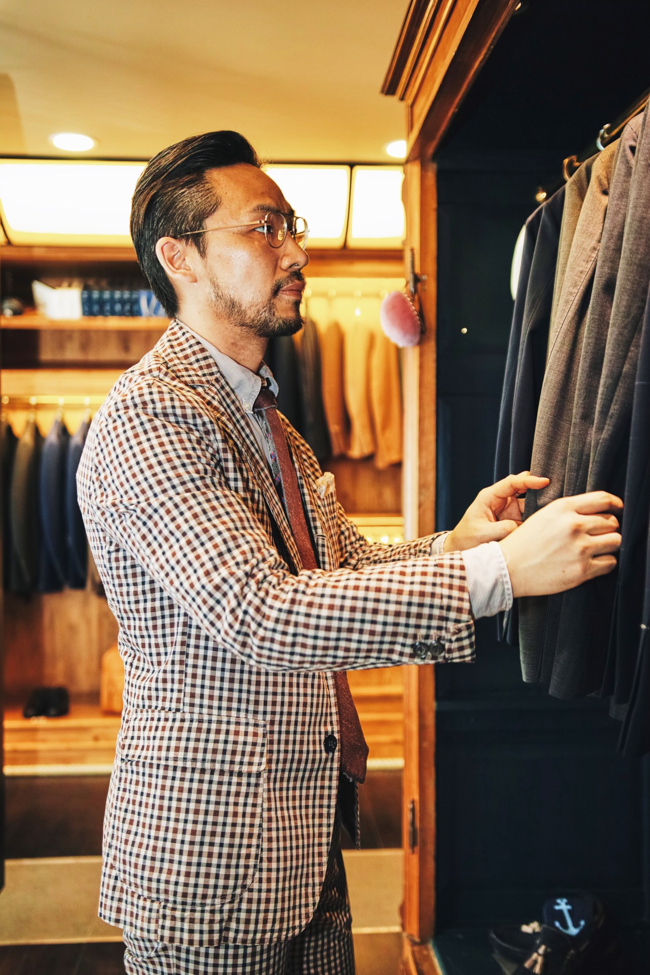 San Francisco Market assistant manager Ko Seung Kyun in a checked blazer examining clothing in the shop