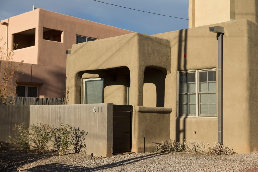 Adobe-inspired houses with stucco facades and flat roofs on Alarid Street in Santa Fe's Railyard neighbourhood.