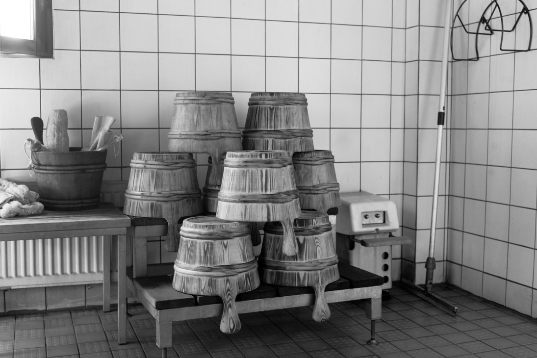 Wooden sauna buckets and ladles arranged in the Finnish Sauna Society's bathing area.