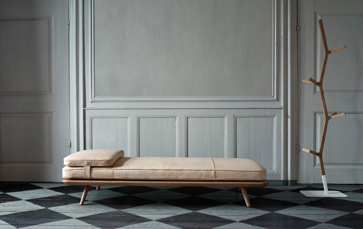 Fredericia Spine Daybed with lacquered oak frame and cream cushioning in minimalist interior.