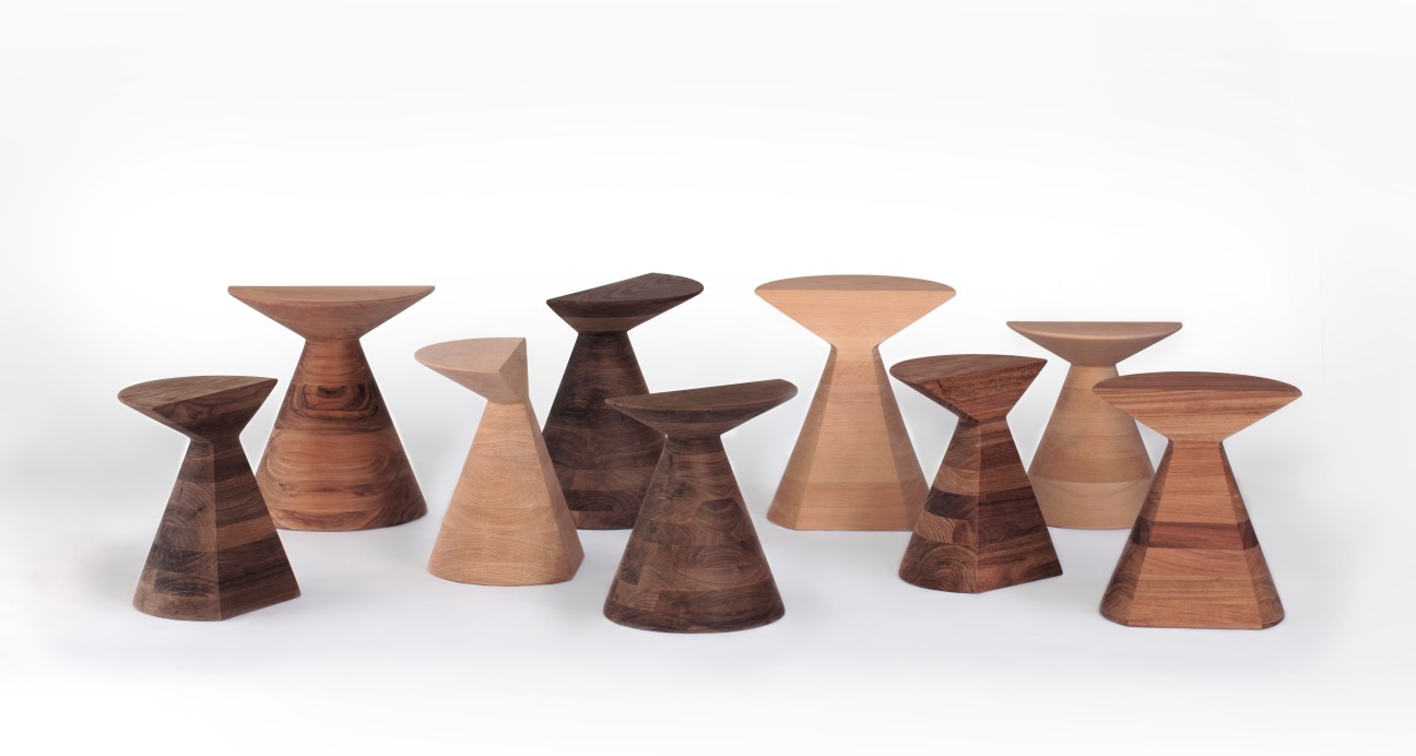 Collection of sculptural wooden stools by Héctor Esrawe in varying wood tones with conical and organic forms.