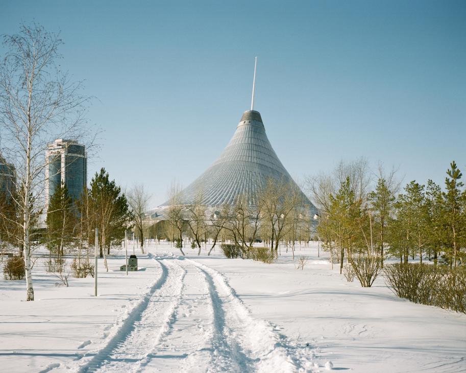 Khan-Shatyr Entertainment Center's distinctive tent-shaped structure rises above snow-covered ground in Astana, Kazakhstan.