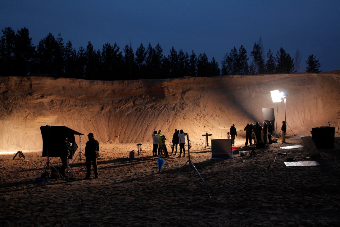 Film crew shooting 'Nightsatan and the Loops of Doom' at night in a sand quarry with equipment and lighting.