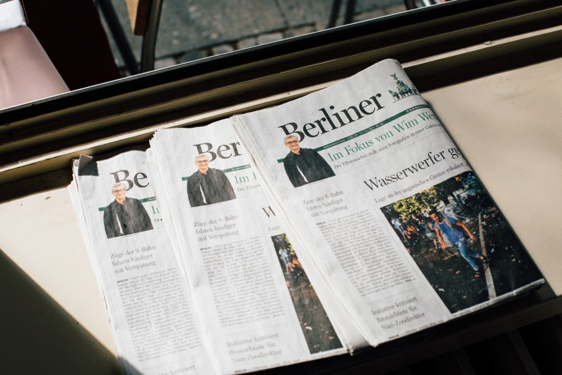 Berliner Morgenpost newspaper featuring Wim Wenders on the cover, displayed on a table.