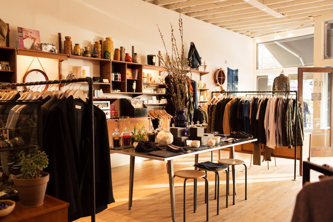 Interior of Mohawk General Store showing wooden shelving, clothing racks, and curated home goods.