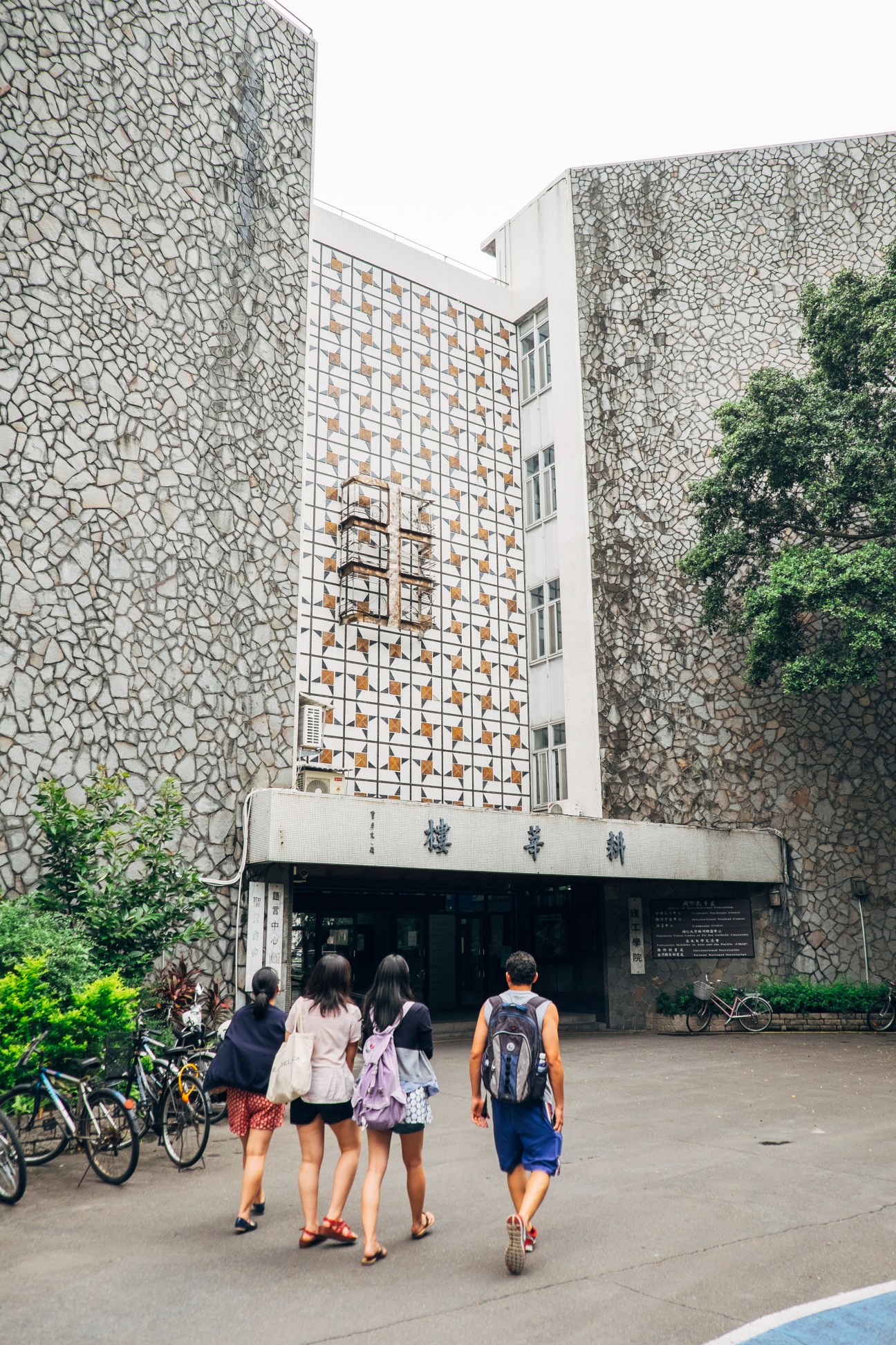 Students walking toward the Office of International Education building at Fu Jen Catholic University in Taipei