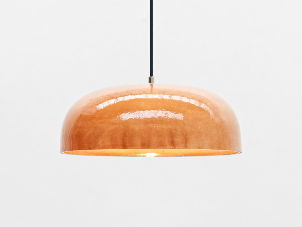 FÃ pendant light by Snickeriet with copper dome shade and black cord against white background.