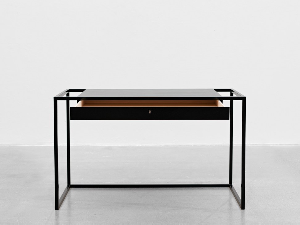 Verk desk by Stockholm-based Snickeriet with black metal frame and wood drawer.