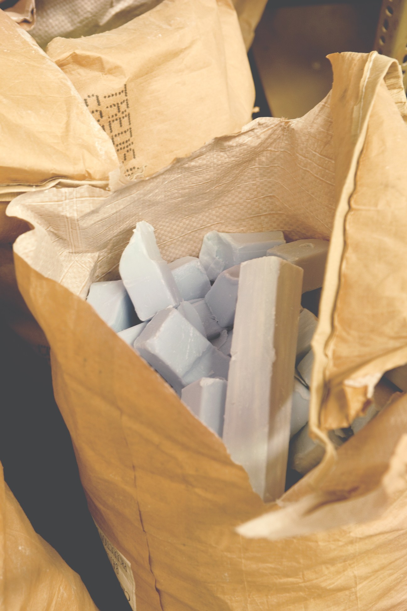 White soap scraps in kraft paper bags waiting for reprocessing at Ach. Brito factory.