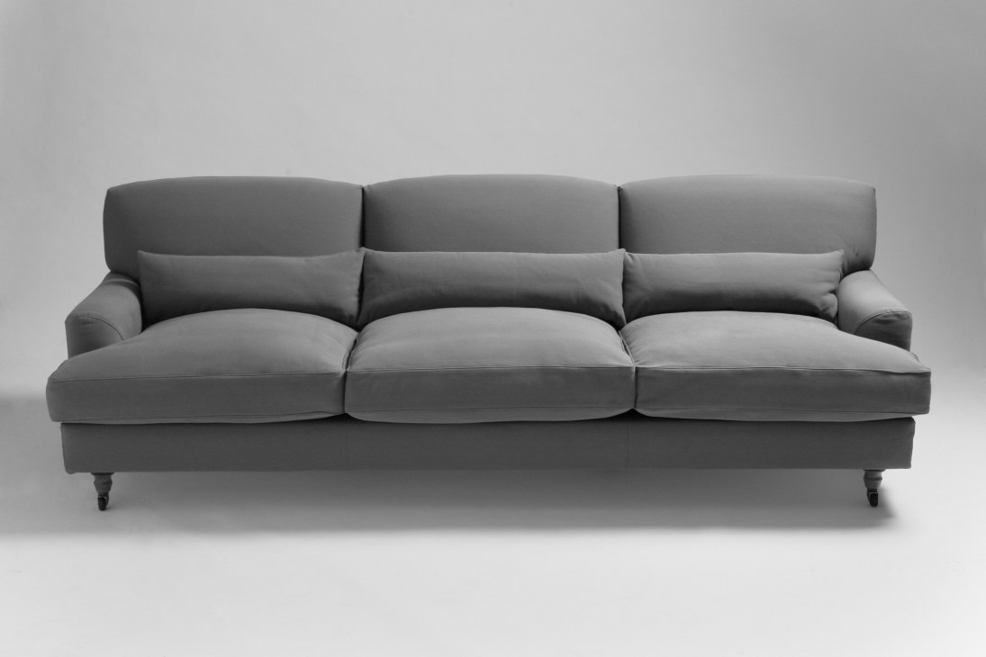 De Padova Raffles sofa, a three-seat gray upholstered design with rolled arms and turned legs.