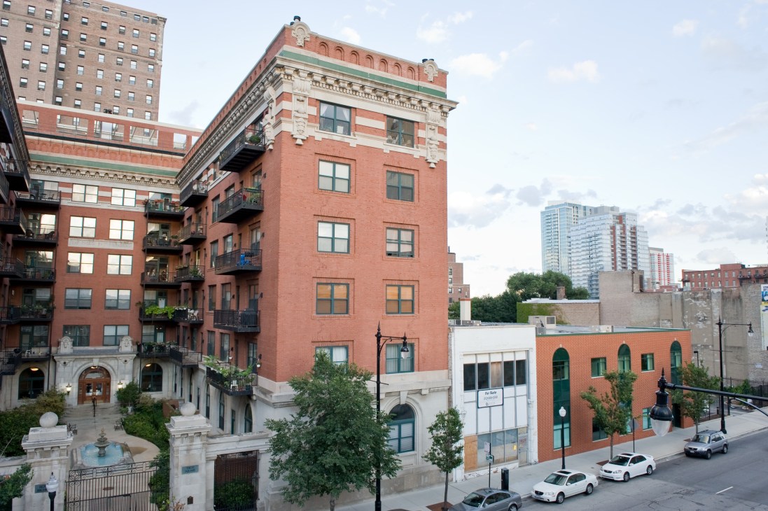 Chicago South Loop street with historic red brick buildings and modern high-rises in background