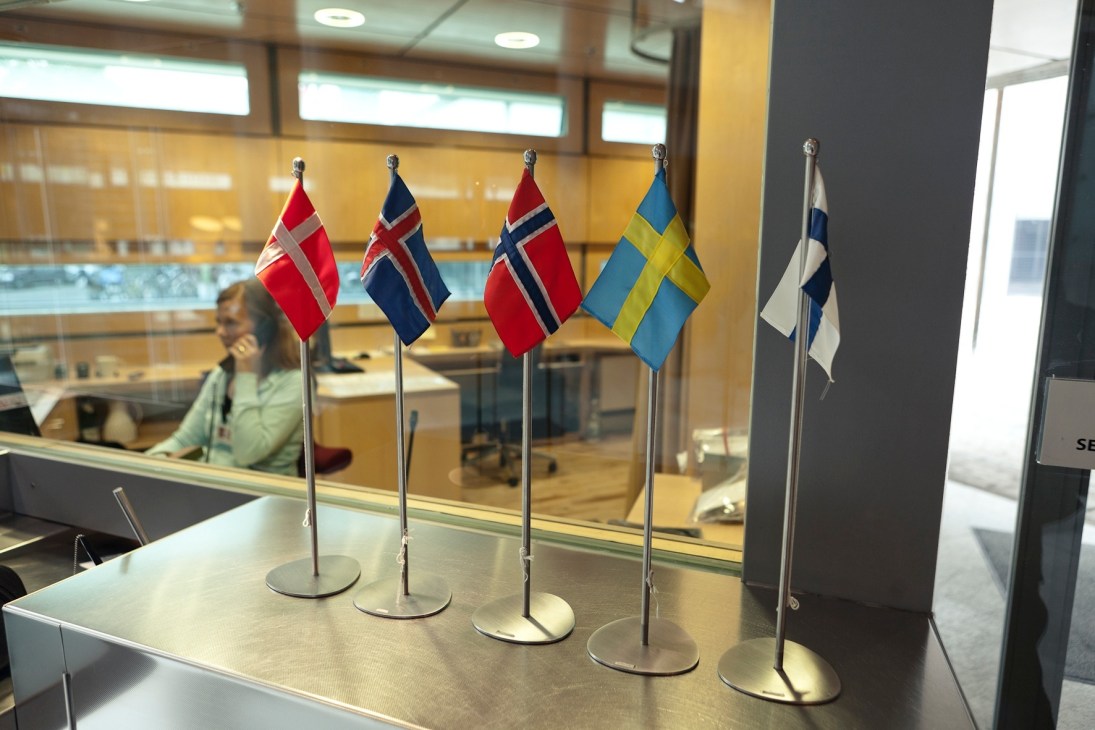 Nordic flags displayed on a reception desk at the Felleshus shared embassy in Berlin.