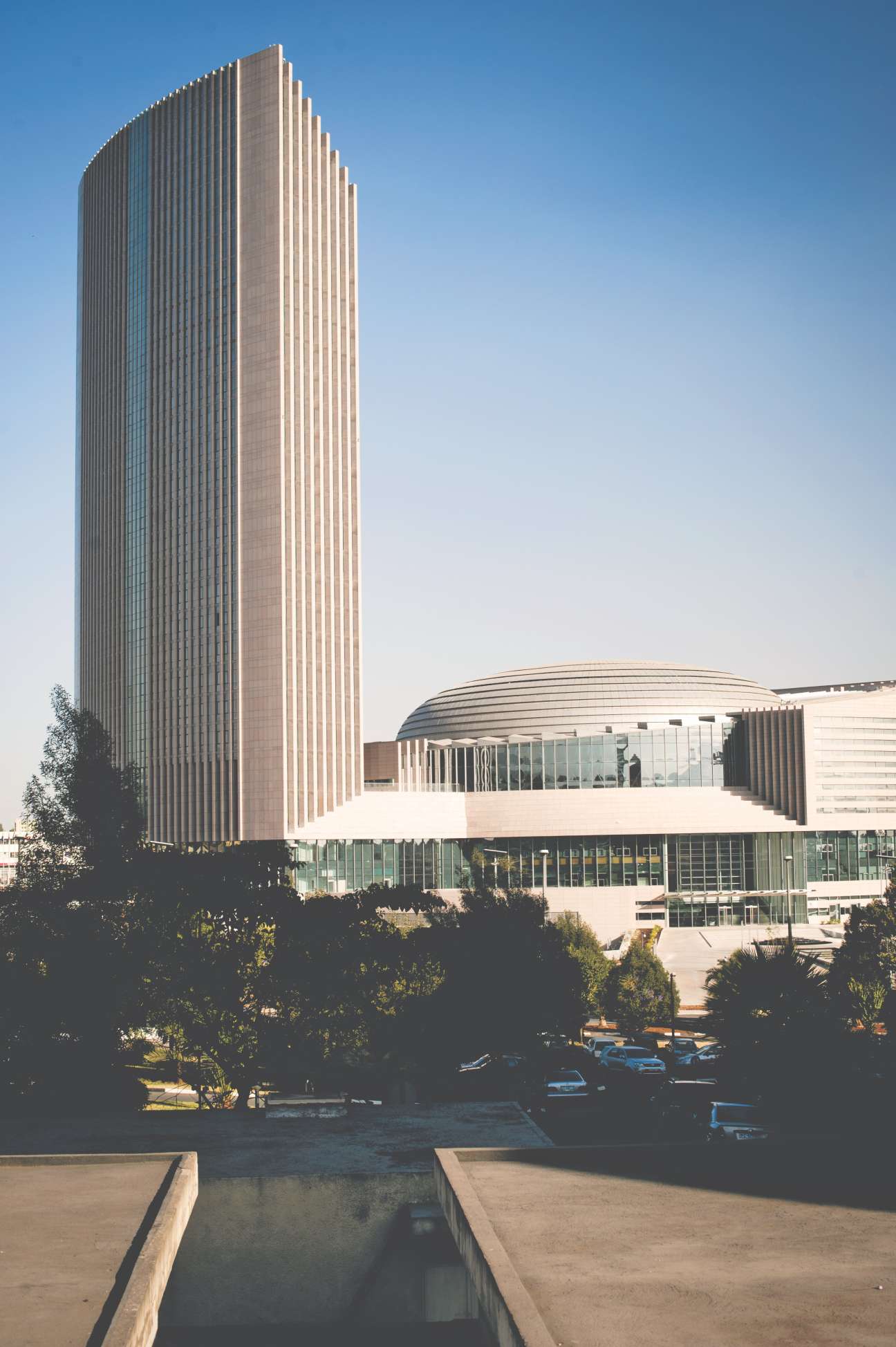 The 24-storey African Union Conference Center tower with vertical ribbed grey marble cladding and dome structure in Addis Ababa.
