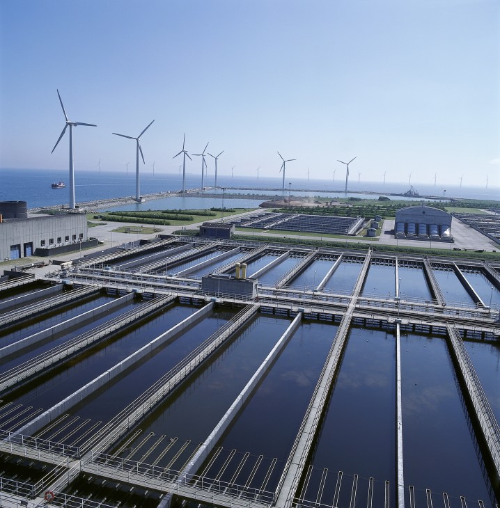 Danish water treatment facility with wind turbines and renewable energy infrastructure visible across the landscape.