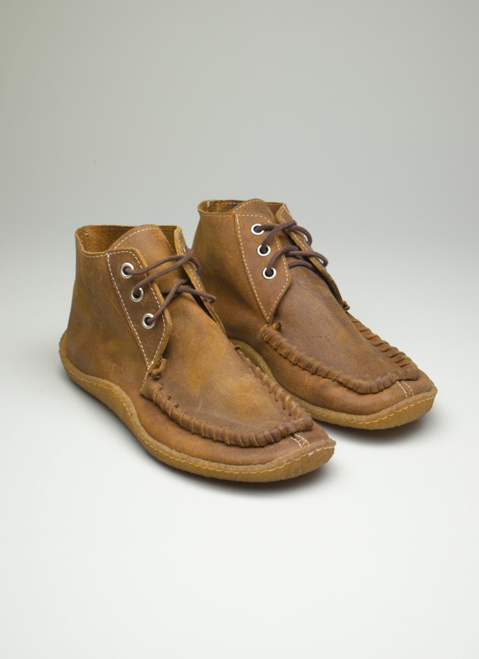 Pair of tan leather lace-up boots with moccasin-style stitching by Punto Pigro.