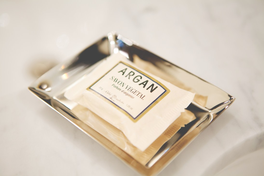 Argan soap package with gold and cream packaging on a white surface.