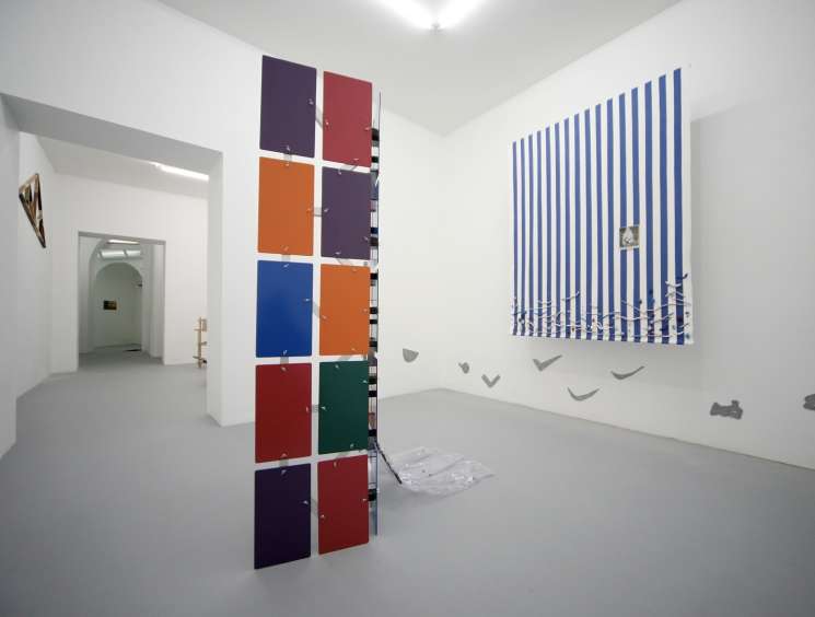 Interior of T293 gallery in Naples with colorful geometric artworks displayed on white walls.