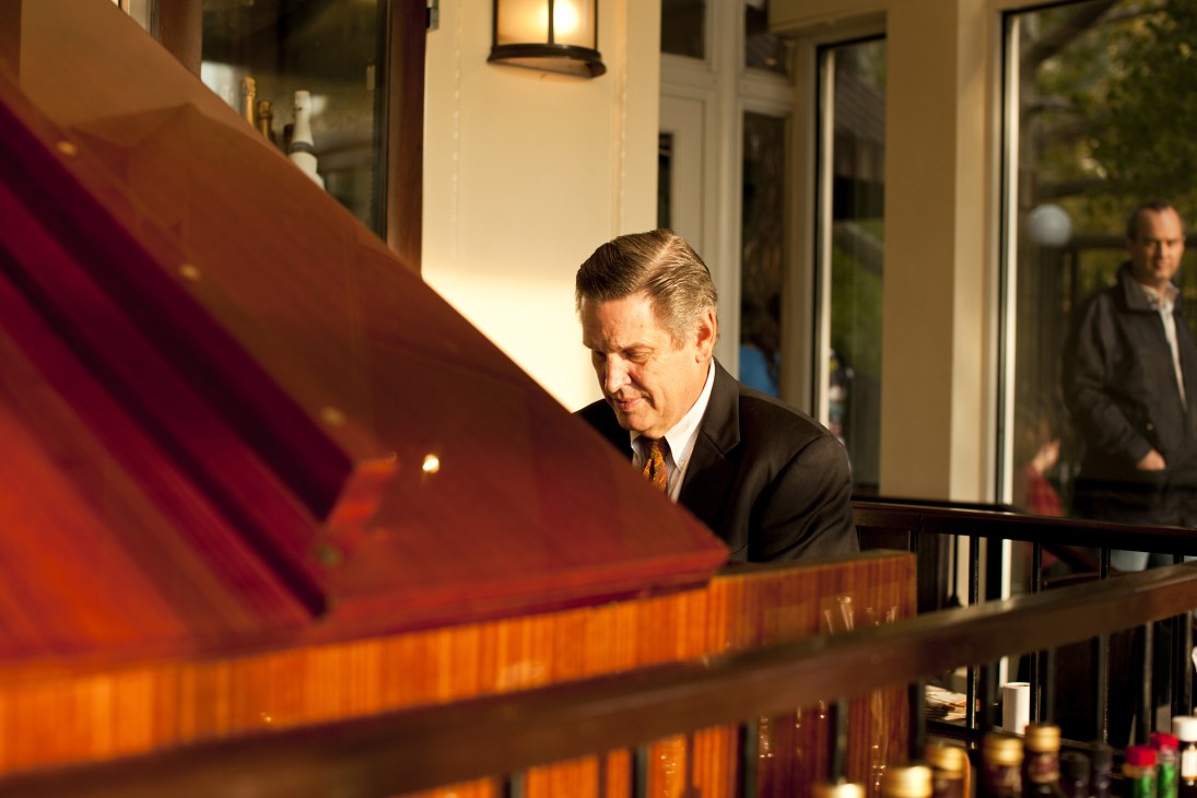 Pianist playing at the Central Park Boathouse restaurant with elegant interior lighting.