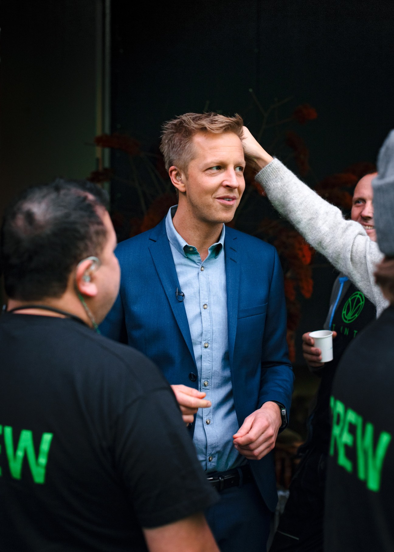 Fridtjof Nilsen, host of 'Lost in Time', in blue blazer and light blue shirt speaking with studio crew members.