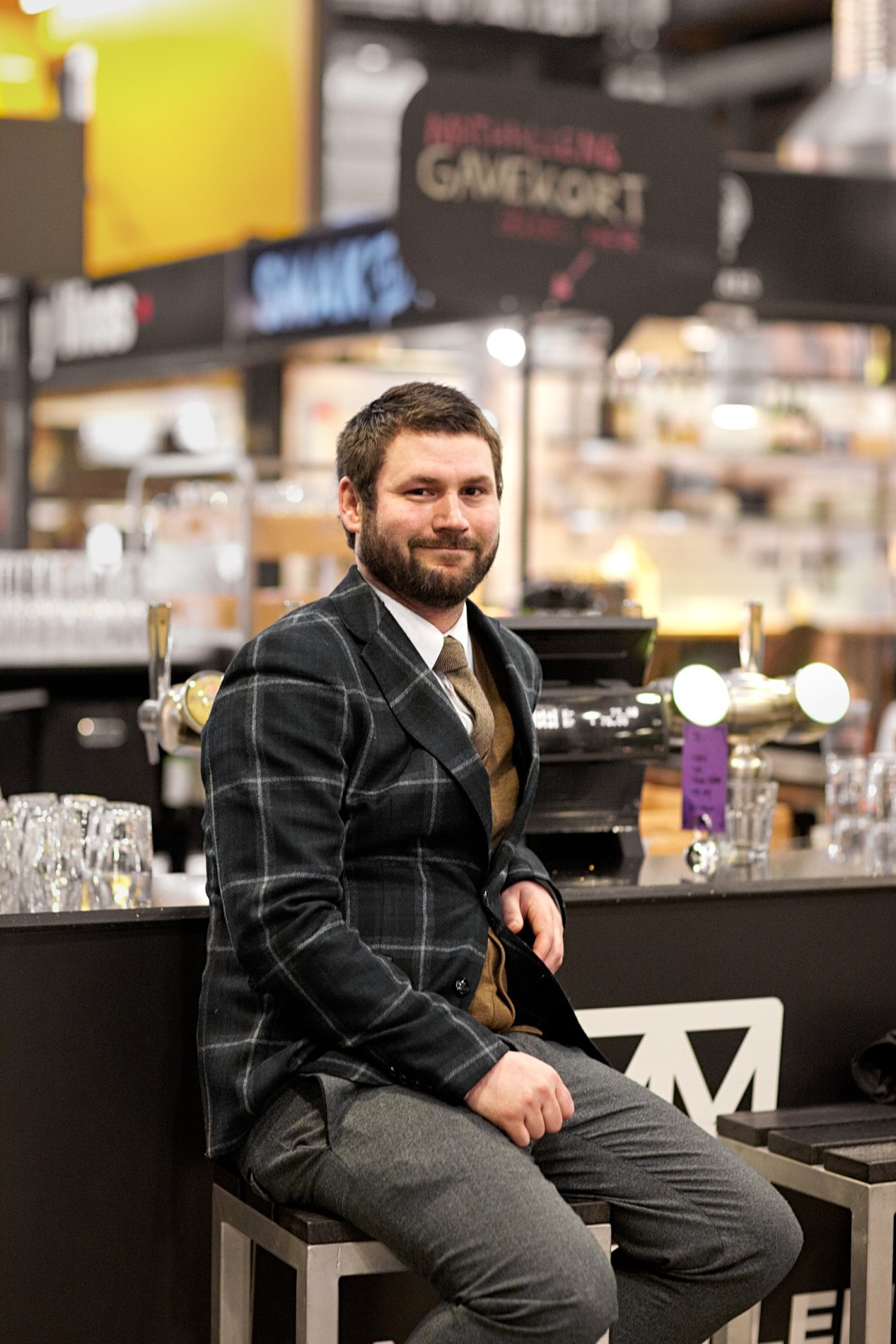 Mathias Steinbru, part-owner of Von Porat, sits at a bar counter in the Mathallen food hall.