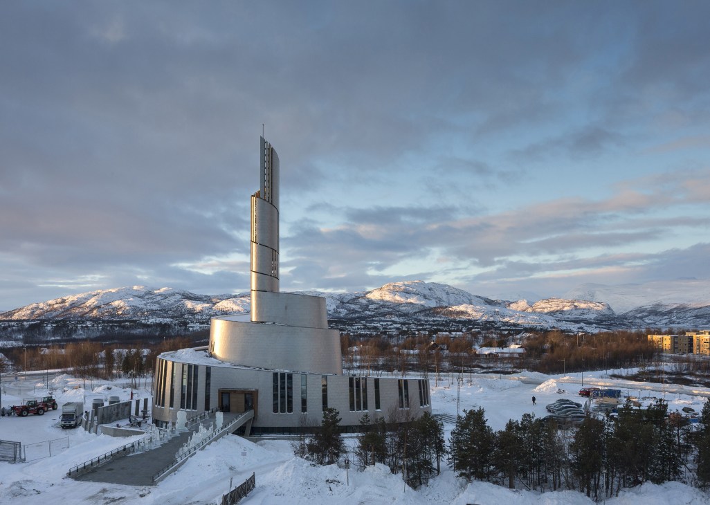 Cathedral of the Northern Lights in Alta, Norway, with titanium exterior and 47-metre spiral tower in snowy landscape.