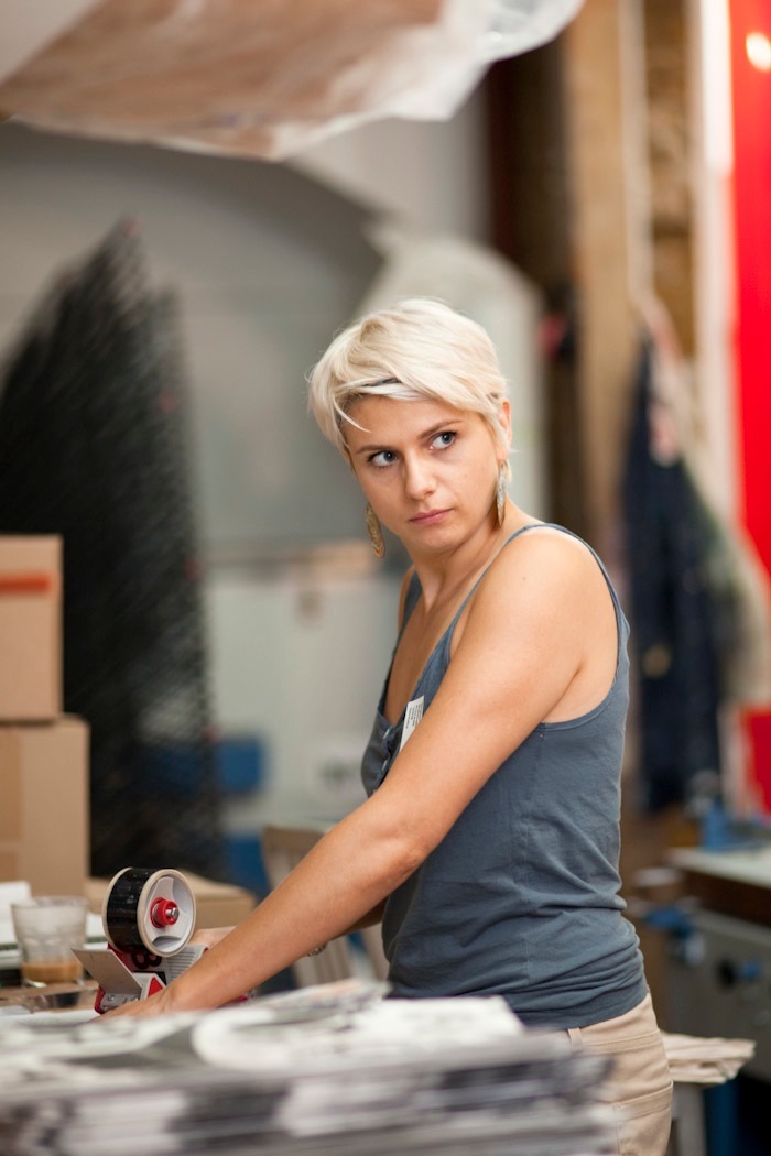 Ann Lou from Nobrow Press in the studio workspace holding tape dispenser