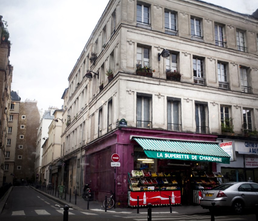 Corner produce shop La Superette de Charonne on a Parisian street with traditional Haussmann-style buildings.