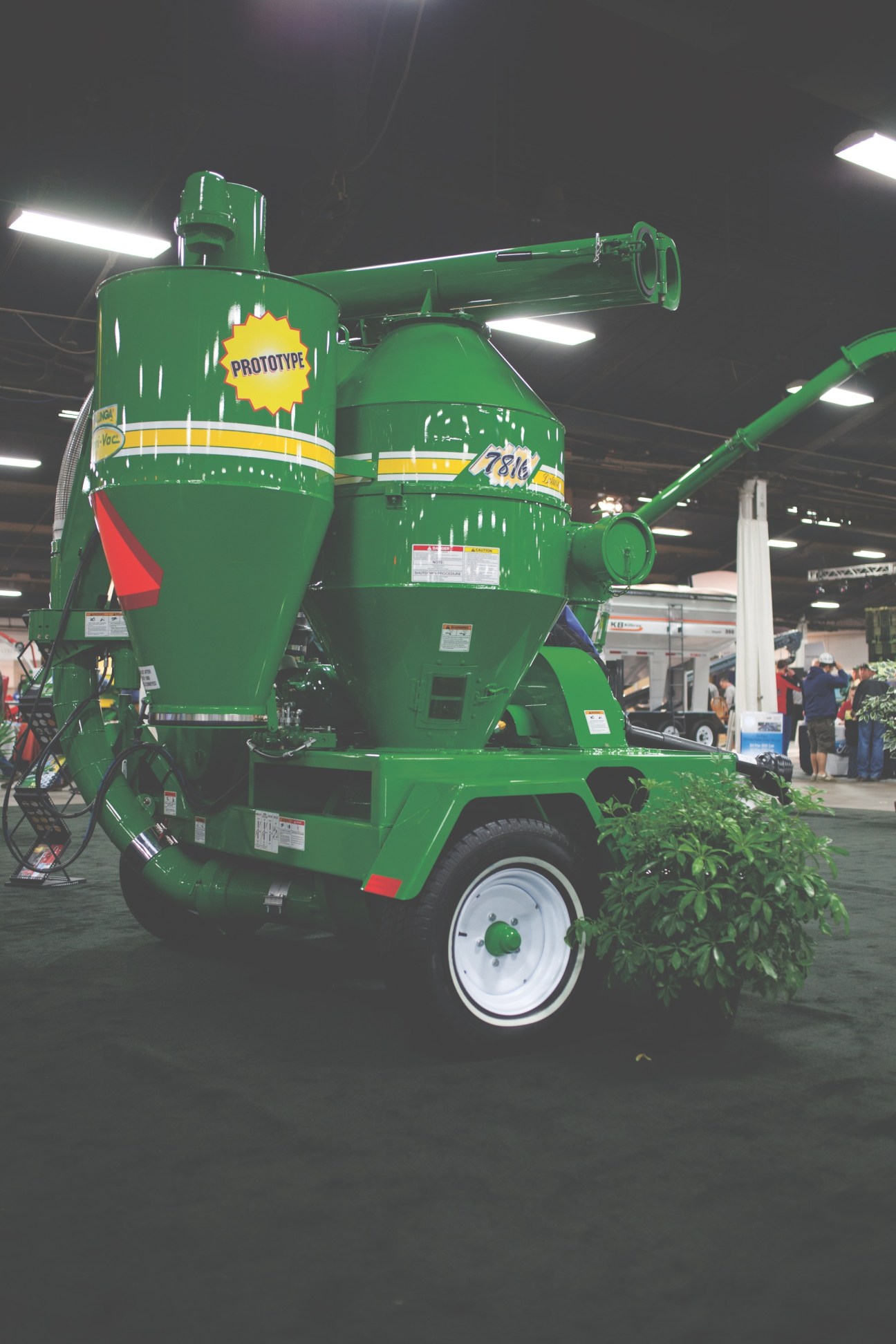 Green prototype seed planter with yellow accents displayed at the National Farm Machinery Show.