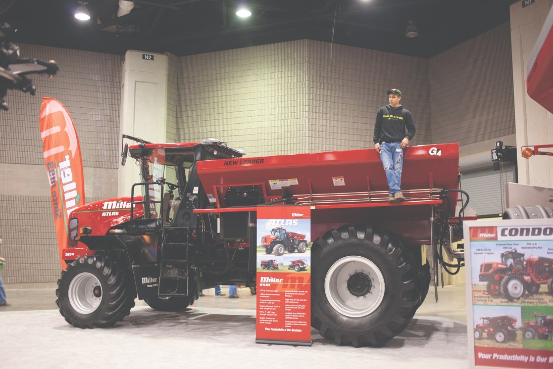 Red farm equipment on display at the National Farm Machinery Show exhibition hall.