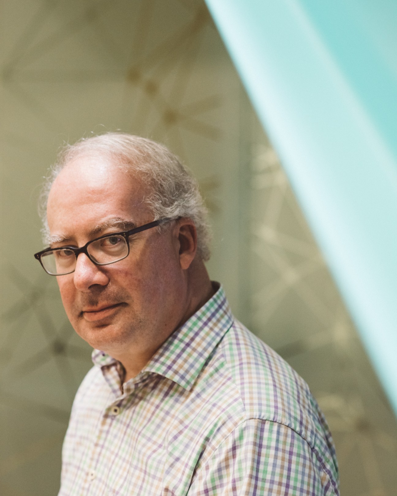 Mark Schmitt, political reform programme director at New America, wearing glasses and a checkered shirt.