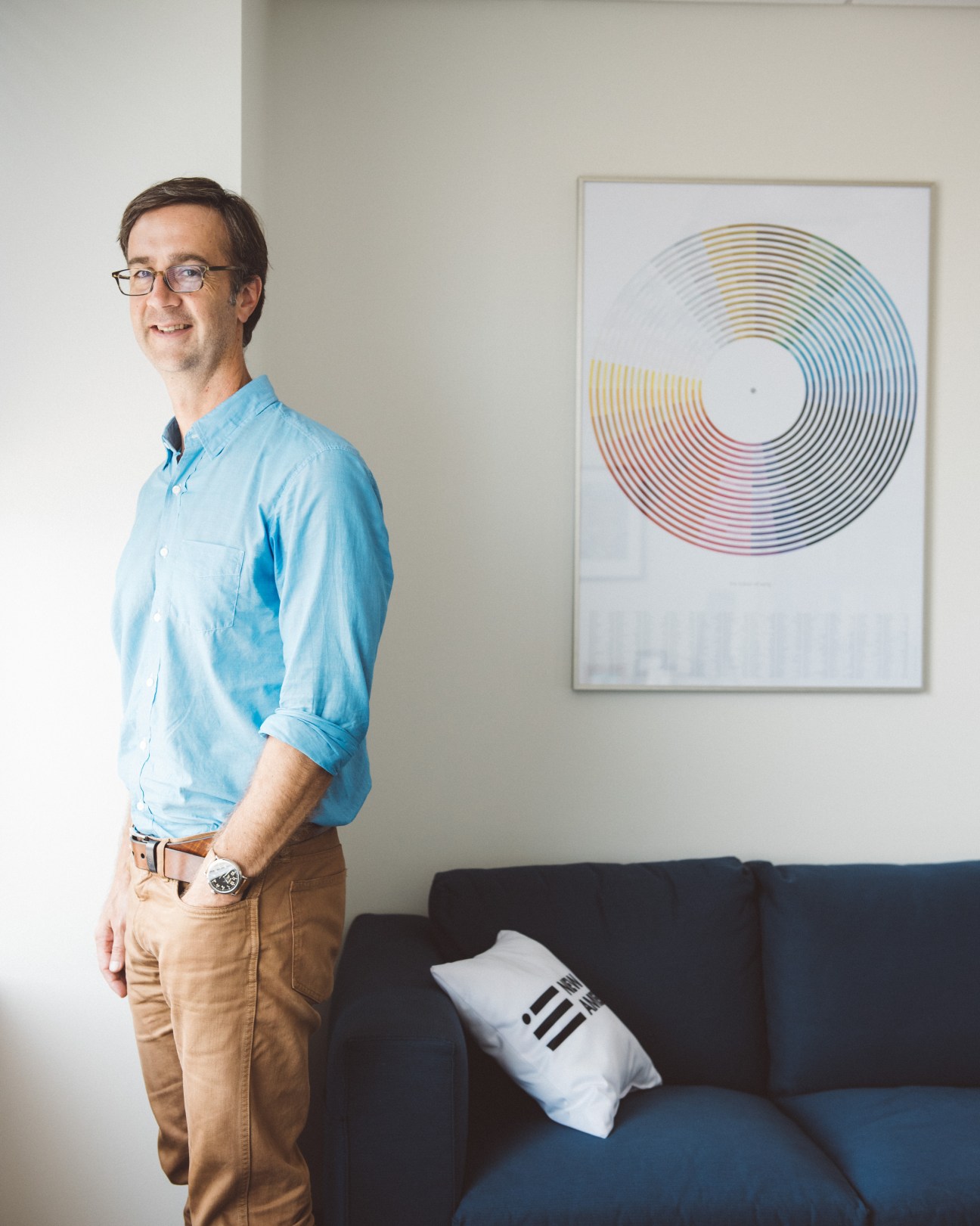 Kevin Carey, educational reform programme director at New America, stands beside a black sofa in an office.