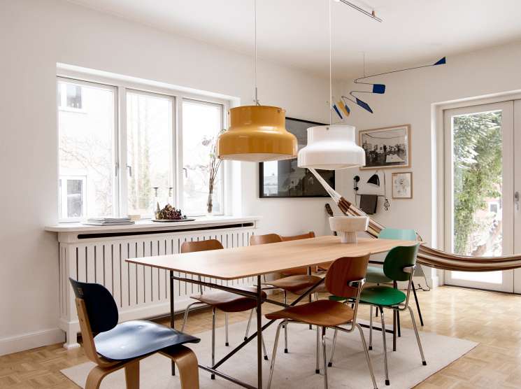 Dining room with Egon Eiermann table and chairs by Please Wait To Be Seated, pendant lights, and skylight.