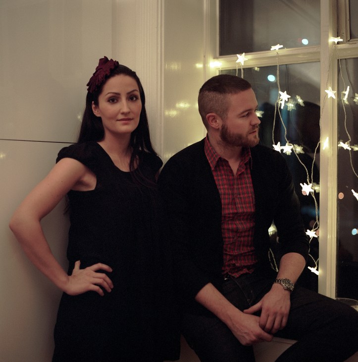 Commercial director Thorhallur Saevarrsson and his girlfriend posing indoors with decorative star lights.