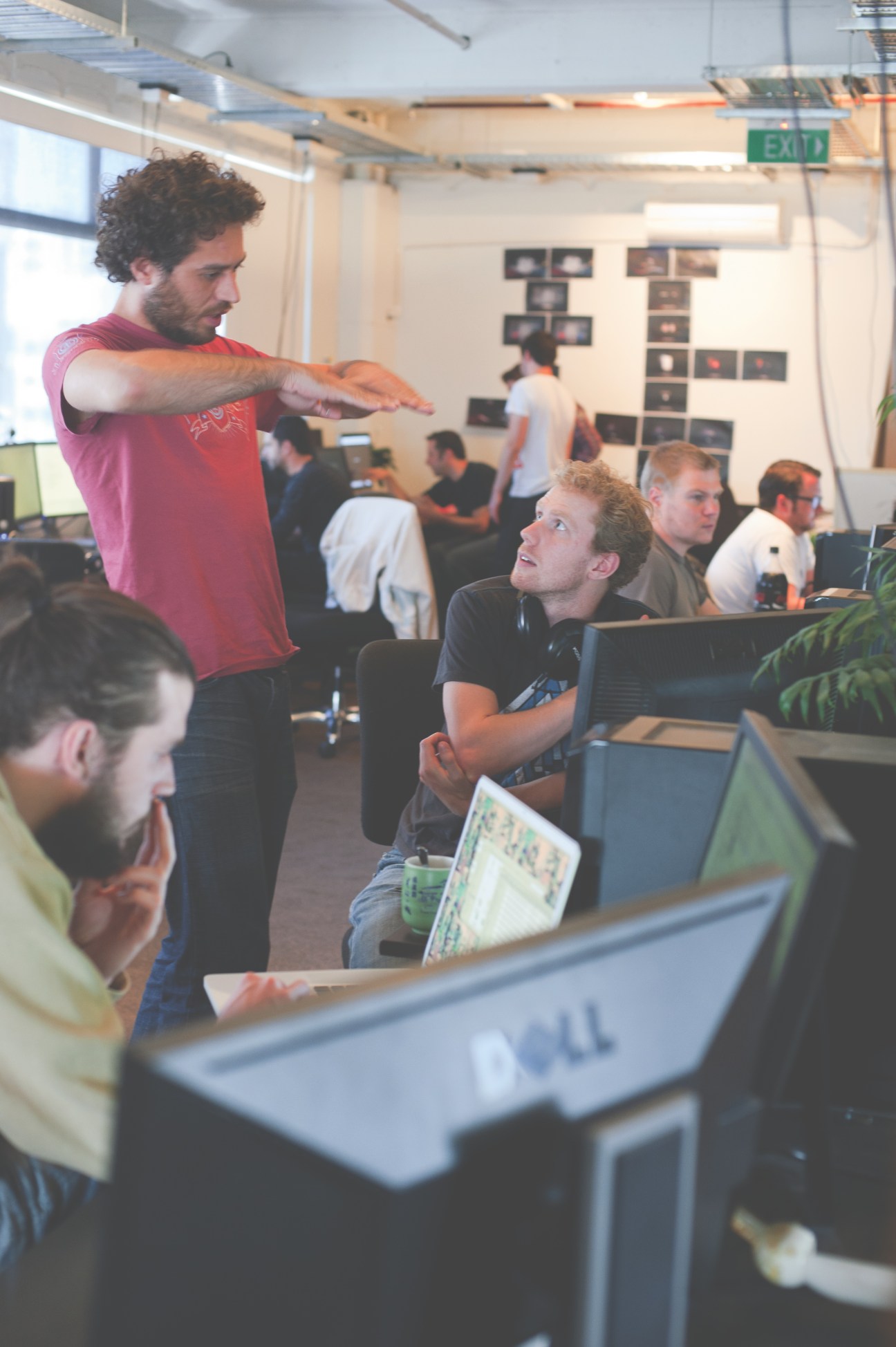 Team members collaborate in Resn's open office space with computers and design work visible on walls.