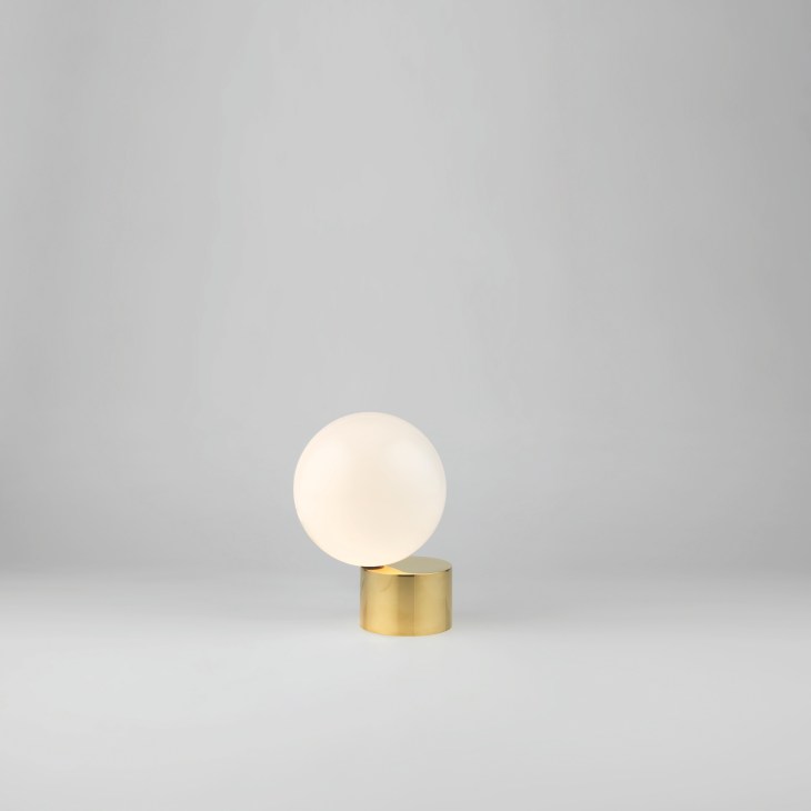 Michael Anastassiades' Tip of the Tongue lamp with brass base and blown glass sphere.