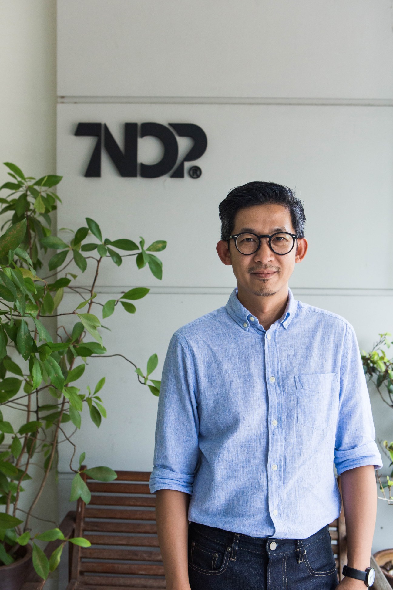 Tnop standing outside Tnop Design's office in Bangkok's Bangkhen district