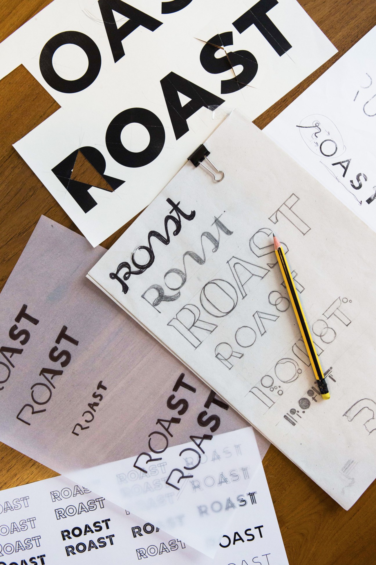 Design sketches for Roast coffee shop showing hand-drawn typography and logo concepts on white paper with pencil