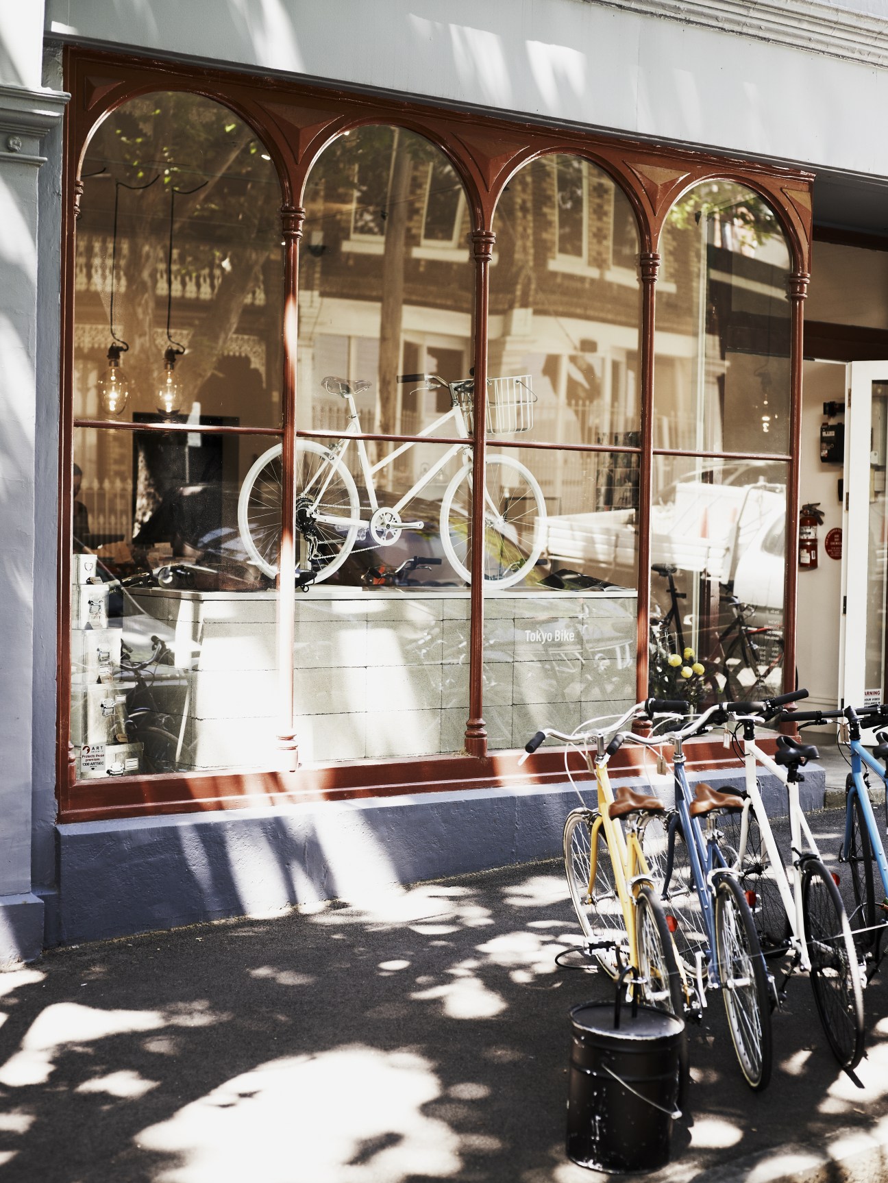 Tokyo Bike storefront with arched windows displaying bicycles and merchandise on Collingwood street.