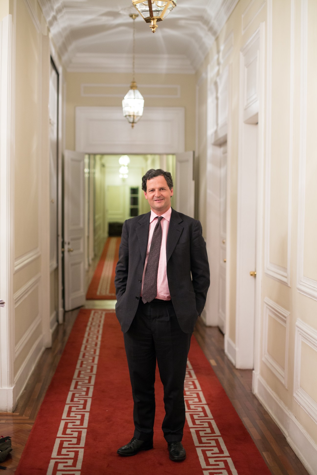 Sergio Jaramillo Caro, Colombian president's peace envoy, standing in a formal hallway with cream walls and red carpet.