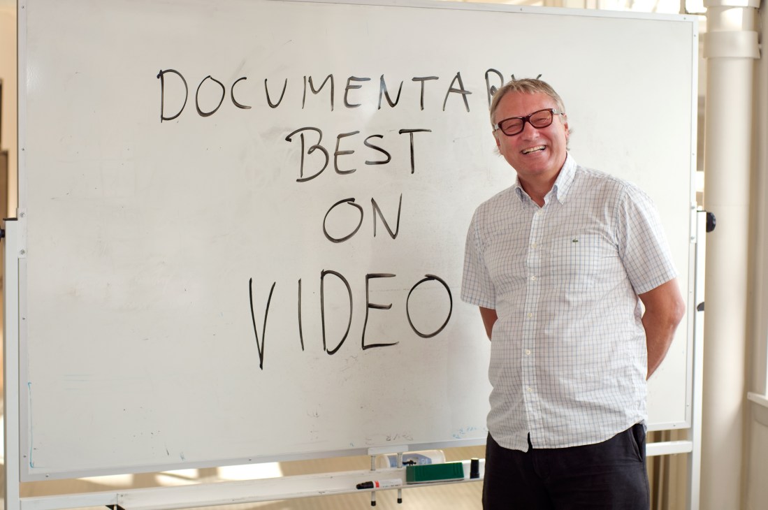 Stig Andersen, director of the Norwegian Film Institute, standing beside a whiteboard with handwritten text reading 'DOCUMENTA BEST ON VIDEO'.