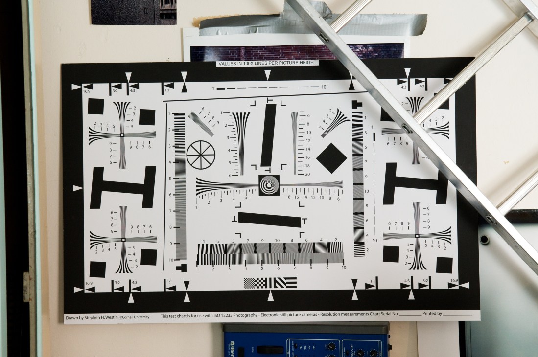 A technical resolution chart for electronic still imaging with black and white test patterns, scales, and measurement markers.