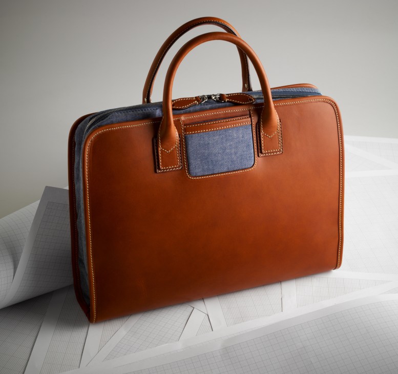 Trash bag by Travelteq and Tenue de Nîmes in cognac leather with blue denim accents and handles.
