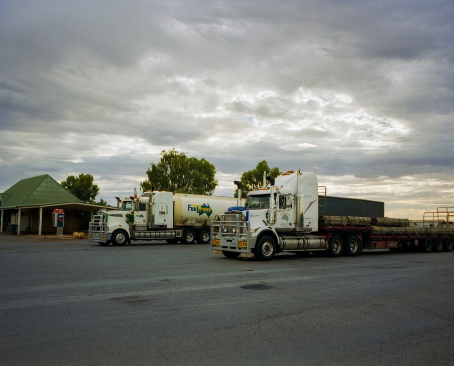 Semi-trailer trucks parked at a roadhouse fuel station in Mount Magnet, Western Australia.