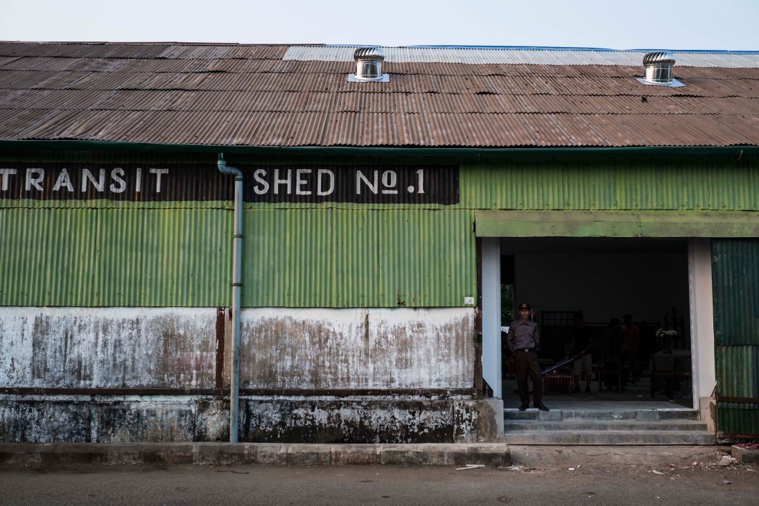 Exterior of Transit Shed No. 1 in Yangon showing weathered corrugated iron and green metal cladding with signage.