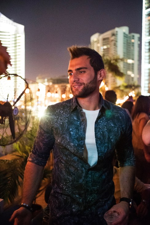 Man in patterned dark shirt at St Georges Hotel nightlife venue in Beirut.