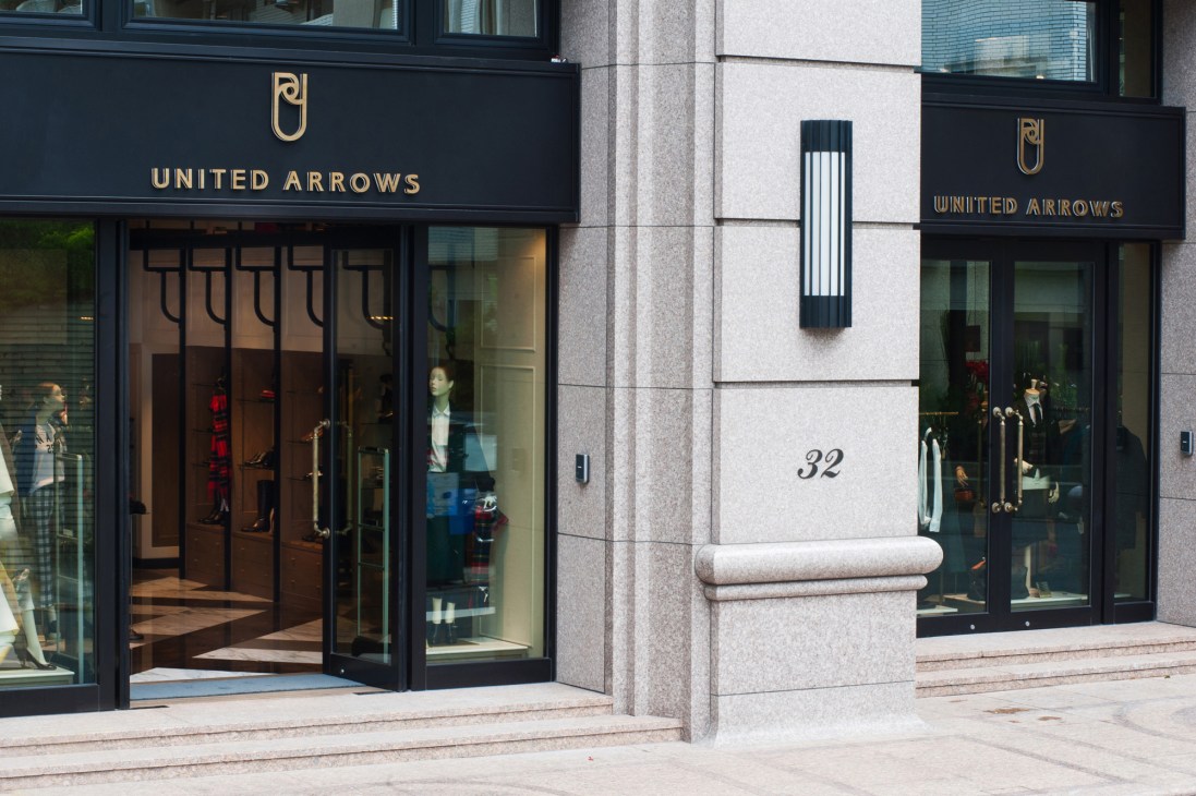 United Arrows storefront with black signage and window displays on a street in Taipei.