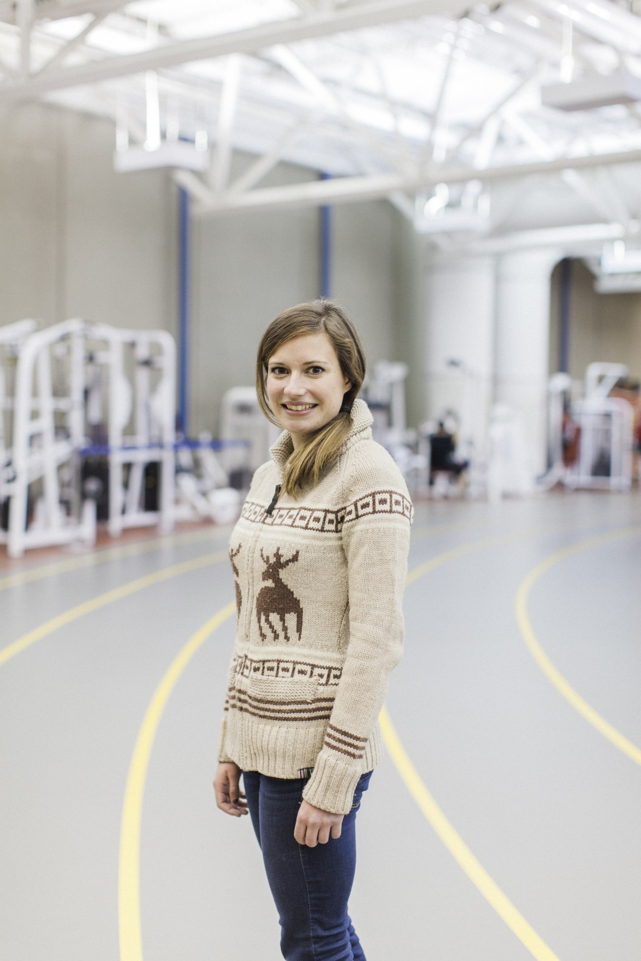 Track-running specialist Jessica O'Connell smiling at camera in University of Calgary Human Performance Laboratory.