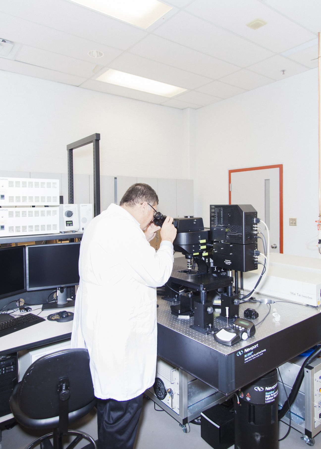 Researcher using a laser-scanning microscope in the Human Performance Laboratory at the University of Calgary.