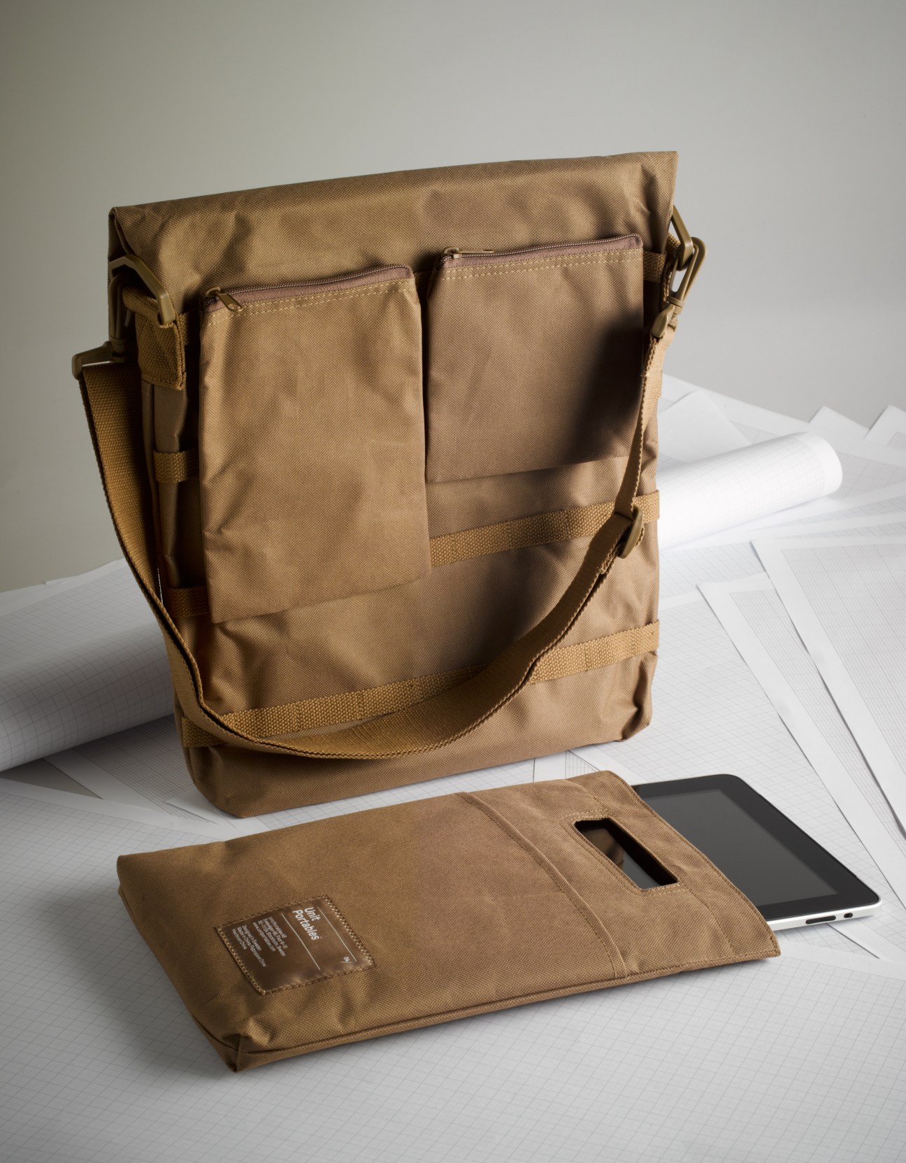 Unit Portables tan modular bags with customisable pouches displayed with tablet device.